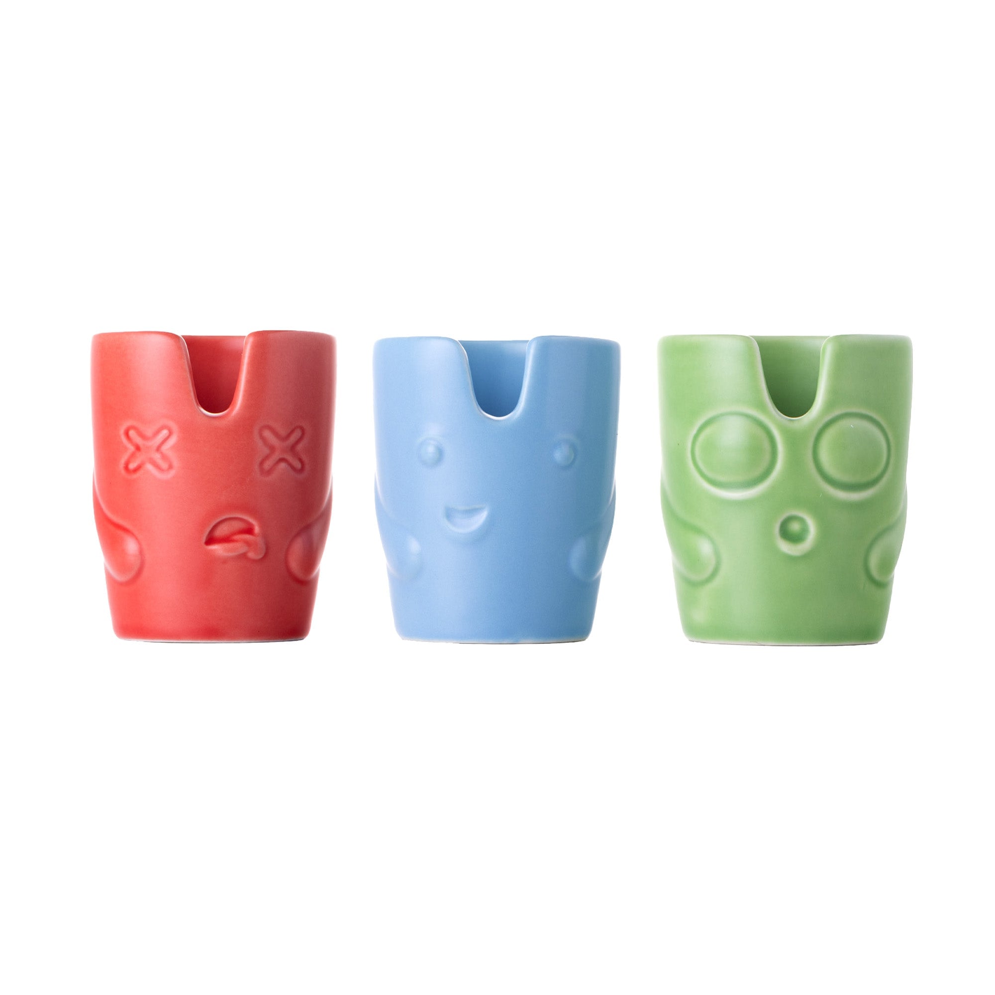 The BigFUN! Potheads Ashtray Set includes three small, colorful ceramic cups with embossed cartoon faces: red with X eyes, blue smiling, and green with calm indents, all set against a white background.