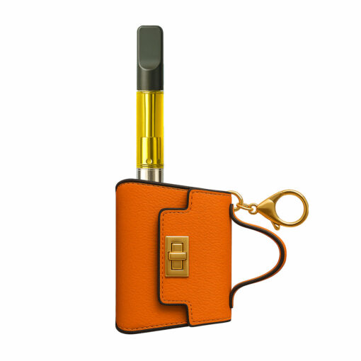 The Penjamin Pursejamin Vaporizer, featuring a yellow liquid cartridge, is partially enclosed in an orange textured leather case with a gold clasp and keyring against a crisp white background.