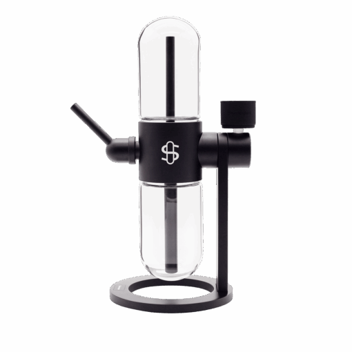 A modern black and glass cold brew coffee maker with cylindrical chambers, a side spout, and a minimalist stand—its innovative design draws inspiration from the Stündenglass Gravity Infuser 360° Gravity Hookah & Infusion System.