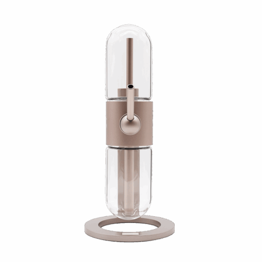 The Stündenglass Gravity Infuser - Desert Rose | 360° Gravity Hookah features a modern minimalist design with clear glass top and bottom, a central metallic ring with lever, and a circular beige base, set against a white background.