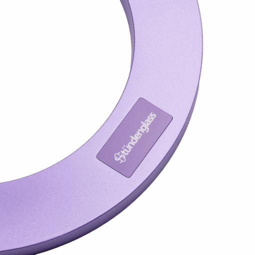 A close-up of the Stündenglass Gravity Infuser - Violet Purple | 360° Gravity Hookah, a circular metallic device with a "studerglass" label on a white background.