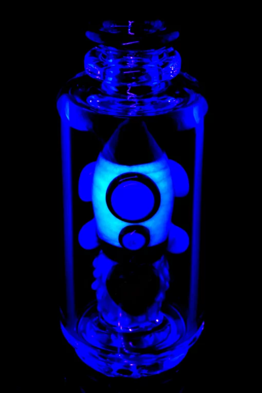 Empire Glassworks Glow Rocket Ship Peak Attachment, a 4½-inch US-made accessory designed to enhance your Puffco setup. This compact, glow-in-the-dark attachment features a whimsical rocket ship design, showcasing vibrant colors and intricate detailing that adds a playful yet functional aesthetic to your cannabis collection. Perfect for those who appreciate unique and artistic smoking accessories, available exclusively at Cannabox.