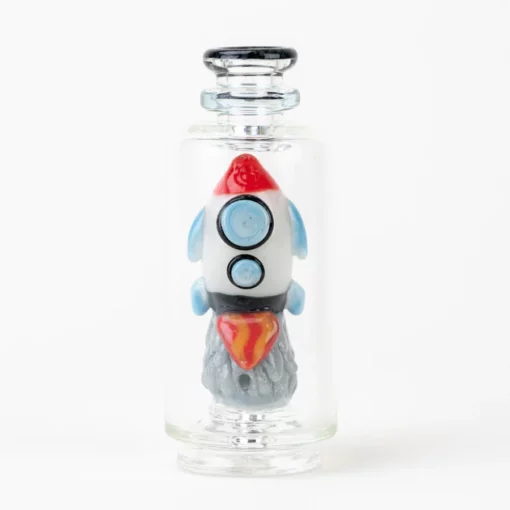 Empire Glassworks Glow Rocket Ship Peak Attachment, a 4½-inch US-made accessory designed to enhance your Puffco setup. This compact, glow-in-the-dark attachment features a whimsical rocket ship design, showcasing vibrant colors and intricate detailing that adds a playful yet functional aesthetic to your cannabis collection. Perfect for those who appreciate unique and artistic smoking accessories, available exclusively at Cannabox.
