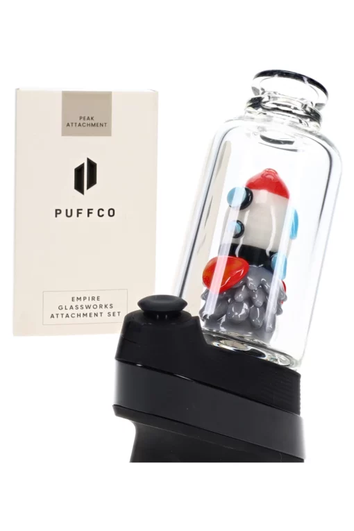 Empire Glassworks Glow Rocket Ship Peak Attachment, a 4½-inch US-made accessory designed to enhance your Puffco setup. This compact, glow-in-the-dark attachment features a whimsical rocket ship design, showcasing vibrant colors and intricate detailing that adds a playful yet functional aesthetic to your cannabis collection. Perfect for those who appreciate unique and artistic smoking accessories, available exclusively at Cannabox.