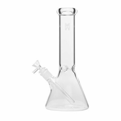 A beautifully handcrafted 12-inch beaker water pipe by Human Grade, showcasing its sleek design and durable construction. The glass pipe features a wide base for stability and a smooth neck for comfortable use, making it an essential addition to any cannabis enthusiast's collection. Ideal for enhancing the smoking experience with both functionality and aesthetic appeal, this piece is perfect for those who appreciate upscale cannabis culture. Available at Cannabox.