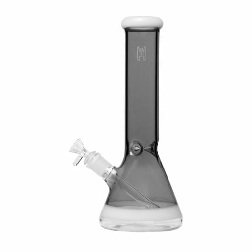 A beautifully handcrafted 12-inch beaker water pipe by Human Grade, showcasing its sleek design and durable construction. The glass pipe features a wide base for stability and a smooth neck for comfortable use, making it an essential addition to any cannabis enthusiast's collection. Ideal for enhancing the smoking experience with both functionality and aesthetic appeal, this piece is perfect for those who appreciate upscale cannabis culture. Available at Cannabox. - Smoke