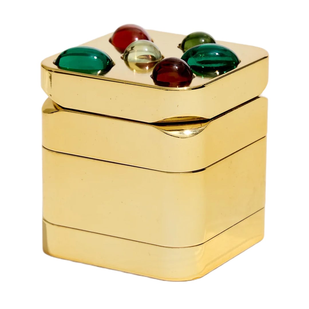 Edie Parker Gemstoned Grinder, a luxurious and stylish smoking accessory from Flower by Edie Parker, featuring a stunning gem-like design that combines glam with functionality. The grinder showcases an ultra-strong magnetic closure for a seamless grinding experience, making it an essential tool for everyday smokers. Perfectly crafted to enhance both the aesthetic and practical aspects of your smoking routine, available at Cannabox. - Gold