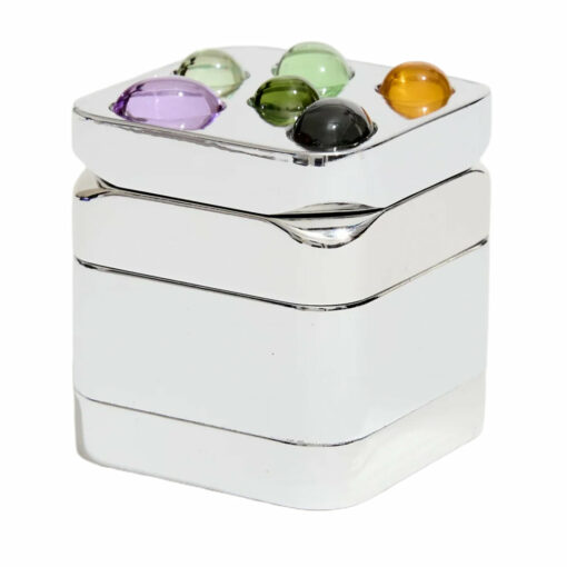 Edie Parker Gemstoned Grinder, a luxurious and stylish smoking accessory from Flower by Edie Parker, featuring a stunning gem-like design that combines glam with functionality. The grinder showcases an ultra-strong magnetic closure for a seamless grinding experience, making it an essential tool for everyday smokers. Perfectly crafted to enhance both the aesthetic and practical aspects of your smoking routine, available at Cannabox. - Silver