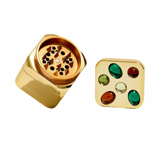 Edie Parker Gemstoned Grinder, a luxurious and stylish smoking accessory from Flower by Edie Parker, featuring a stunning gem-like design that combines glam with functionality. The grinder showcases an ultra-strong magnetic closure for a seamless grinding experience, making it an essential tool for everyday smokers. Perfectly crafted to enhance both the aesthetic and practical aspects of your smoking routine, available at Cannabox.